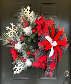 a christmas wreath is hanging on the front door