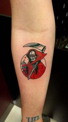 a man with a tattoo on his leg holding a knife and wearing a red robe