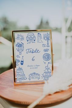 a wooden table topped with a sign that says table 6