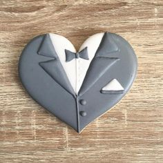 a cookie shaped like a tuxedo and bow tie