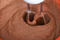 two mixers mixing chocolate batter in a bowl