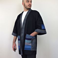 "This Japanese streetwear-style modern noragi jacket is made from black thick cotton fabric. Various fabrics were added to the pockets and sleeves with the patchwork technique. The sleeves are wide and below the elbow. The Men's haori jacket is of a loose fit, we recommend choosing the size you usually wear. The fabric is one of the more popular choices, as it's a breathable and natural fabric that stays cool. - Can be worn at home or outside - Loose fit for extra comfort - No closure - 3/4 slee Black Cotton Cardigan With Pockets, Long Sleeve Cotton Kimono With Pockets, Black Cotton Outerwear With Kimono-style Sleeves, Black Cotton Outerwear With Kimono Sleeves, Winter Black Cotton Kimono, Male Cardigan, Plus Size Male Model, Noragi Jacket, Cardigan Streetwear