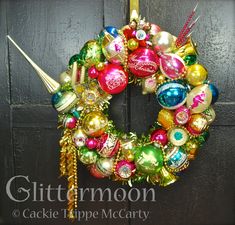 a christmas ornament wreath hanging on a door