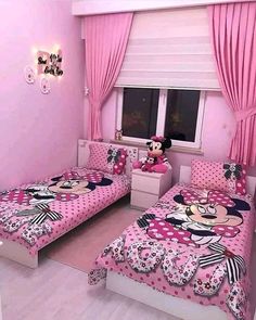 a bedroom decorated in pink and white with minnie mouse bedding