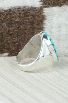 This turquoise and sterling silver inlay ring was made by Zuni silversmith Amy Wesley. The inside is signed Amy.Size: 10Length: 1 1/8"Width: 5/8"Free shipping on all orders! We ship with USPS and always include tracking. All orders ship within a day of payment.Returns are accepted up to 30 days after you receive your order. Just send us a message. Our shop offers cash back or store credit. The item must be returned in the same condition. Oval Turquoise Inlay Rings, Oval Turquoise Rings With Inlay, Artisan Silver Turquoise Ring With Inlay, Oval Turquoise Ring With Sterling Silver Inlay, Classic Sterling Silver Turquoise Ring With Polished Finish, Turquoise Sterling Silver Rings With Polished Finish, Oval Turquoise Engraved Ring In Sterling Silver, Oval Engraved Turquoise Ring In Sterling Silver, Engraved Oval Turquoise Ring In Sterling Silver