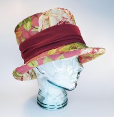 FREE SHIPPING - Satisfaction Guaranteed A soft top hat in romantic deep rose pink floral with cream, green and mustard with a burgundy knit band for a fit that's very comfortable for many many sizes.  The shape is achieved through design, a flexible plastic reed and stitching and it's crush-able and travels well. This is your next hat. This hat fits small to  large heads. Size 7 to 7 1/2  or 56 to 60 cm. This hat was hand made by a real milliner at the studio of Le Petit Chapeau, Orillia, ON. Canada. This hat is shipped in it's own hat box. How to Measure your head: It's very important to measure your head correctly.  There are a few things that you need. *A flexible measuring tape such as a dressmakers tape.  These can be found in any sewing/hobby shop, dollar stores, department stores an Red Brimmed Festival Costume Hats And Headpieces, Red Brimmed Costume Hat For Festival, Red Brimmed Costume Hats And Headpieces For Festivals, Red Brimmed Festival Costume Hat, Red Fedora Top Hat For Kentucky Derby, Red Top Hat With Flat Brim, Red Fitted Hat For Festival, Fitted Red Festival Hat, Red Brimmed Costume Hat One Size