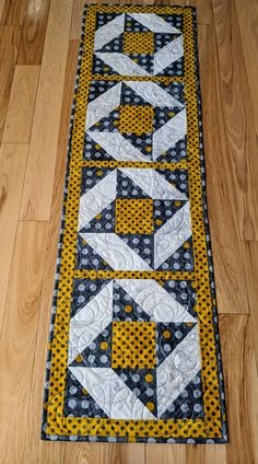 a yellow and black table runner on the floor