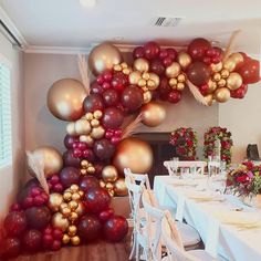 a room with tables, chairs and balloons in the shape of flowers on the wall