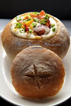 two breads with different types of food on them sitting on a plate next to each other