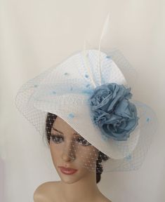 Light blue and white big veil derby fascinator. The hat base is in white color decorated with a sky blue spot veil that wraps all the base, Two white feathers and some roses flowers in pale blue color. It is a Pale Blue original woman wedding hat in Summer colors. It is mounted on a headband that allows to tilt the hat to the liking of each one. You can choose the side of the head where you like to wear the fascinator. The headdress has been hand sewn. If you would like to change any colors or i Blue Summer Wedding Costume Hats And Headpieces, Blue Costume Hats And Headpieces For Summer Wedding, Blue Headpiece For Summer Weddings, Blue Summer Wedding Headpiece, Blue Mini Hat For Spring Wedding, Blue Mini Hat For Royal Ascot Wedding, Blue Fascinator For Church And Kentucky Derby, White Costume Hats And Headpieces For Spring Events, White Summer Costume Hats And Headpieces For Events