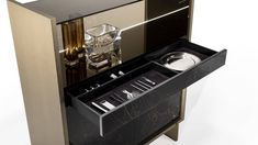 a black and gold cabinet with silverware in it