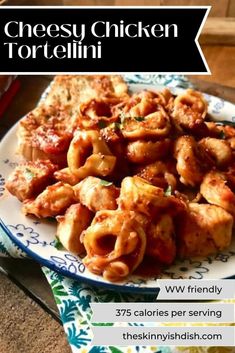 a white plate topped with pasta covered in sauce