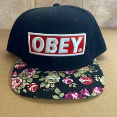 Never Worn, Snapback Hat From Obey Stitched Block Logo With Red And White And Floral Patterned Brim Casual Brimmed Snapback Hat For Streetwear, Casual Brimmed Snapback Hat, Casual Snapback Hat For Streetwear, Casual Streetwear Snapback Hat, Casual Black Brimmed Snapback Hat, Adjustable Brimmed Snapback Hat For Streetwear, Block Logo, Snapback Hat, Snapback Hats