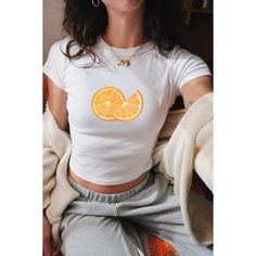 Embrace the vibrant nostalgia of Y2K with our Orange Slices Baby Tee, a flirty crop top reminiscent of coquette vintage fashion. Featuring a playful fruit print design, this girly-girl top is the perfect summer statement piece for women who adore retro charm.  🦢・️✩   ＊ Baby-style tee shirts ੈ༺☆༻*ੈ ᡣ𐭩PRODUCT DETAILS: - The heavy cotton tee is a KIDS SIZE SHIRT, so please size accordingly(using the chart provided).   ᡣ𐭩BABY TEE (YOUTH SIZE - Gildan Brand G5000B  - 100% ethically grown and harvested US cotton  - Midweight fabric (5.3 oz/yd² (180 g/m  *ੈ༺☆༻*ੈ  𐙚 SHIPPING:  - Processing time is 2-5 business days  *ੈ༺☆༻*ੈ ʚɞ SHOP POLICY:   - We do not accept returns and exchanges, but if you have received the wrong/damaged items or quality, send a message with photos, and we can find a solut White Fitted Cropped T-shirt Y2k Style, White Y2k Cropped T-shirt, Y2k Summer Cropped T-shirt, Y2k Style Cropped T-shirt For Summer, Y2k Cropped T-shirt For Summer, Spring Y2k Crew Neck Crop Top, Spring Y2k Style Crew Neck Crop Top, Spring Y2k Crop Top With Crew Neck, Spring Y2k Style Crop Top With Crew Neck