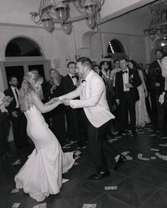 the bride and groom are dancing together in front of their guests at this wedding reception