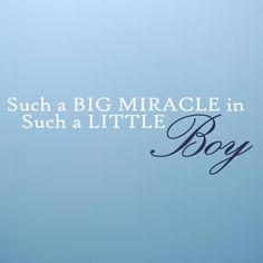 a little boy standing in front of a blue wall with the words, such a big miracle in such a little boy