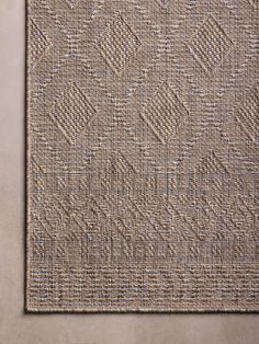 a close up view of the textured fabric on an area rug that has been made from