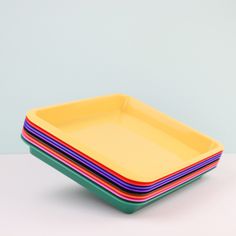 four square plates stacked on top of each other with different colored lines in the middle