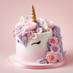 a cake decorated with flowers and a unicorn's head