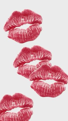 three red lipsticks are arranged in the shape of four lips