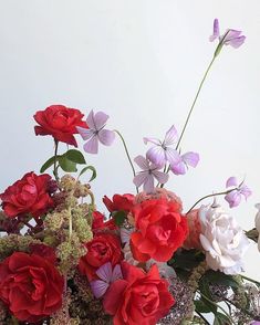 a vase filled with lots of different colored flowers