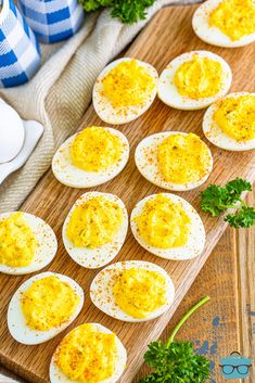 deviled eggs on a cutting board with parsley