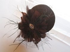 Chocolate Brown Straw Feather and Crystal Fascinator Hat with Veil and Crystal Headband, for wedding Elegant Mini Hats With Feather Trim For Party, Elegant Mini Hat With Feather Trim For Evening, Elegant Mini Hats With Feathers For Gifts, Elegant Mini Hats With Feathers As Gifts, Elegant Mini Hat With Feathers For Gift, Elegant Mini Hat With Feathers As Gift, Elegant Feathered Fascinator For Vintage Events, Elegant Feather Fascinator For Vintage Events, Vintage Mini Hats With Feathers For Party