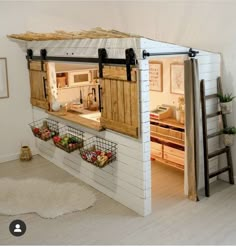 a small kitchen made out of pallet wood with open doors on the front and side