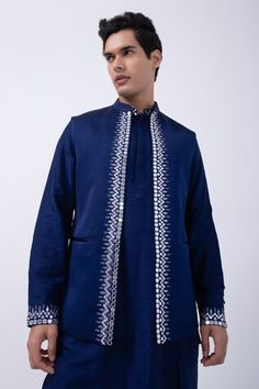 Navy bam silk kurta with mirror embroidered collar and cuffs. Comes with ivory cotton silk pyjama and a linen satin bundi jacket. - Aza Fashions Eid Cotton Silk Nehru Jacket With Gota Work, Eid Nehru Jacket With Gota Work In Cotton Silk, Blue Sherwani With Gota Work, Blue Chanderi Long Sleeve Bandhgala, Blue Bollywood Sherwani With Gota Work, Blue Long Sleeve Chanderi Bandhgala, Traditional Nehru Jacket With Mirror Work In Raw Silk, Traditional Raw Silk Nehru Jacket With Mirror Work, Eid Nehru Jacket With Mirror Work In Raw Silk