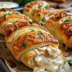 some very tasty looking pastries on a plate with sauce and parmesan cheese