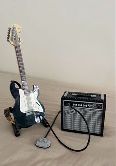 an electric guitar and amp sitting on the floor