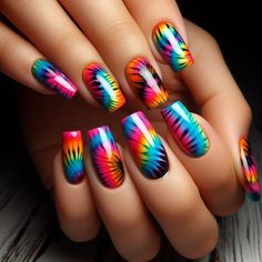 The nails feature a tie-dye pattern with all the colors of the rainbow. The colors blend and swirl together in a unique and vibrant design on each nail. The tie-dye effect is lively and fun, with a glossy top coat adding a smooth and shiny finish. Short Rave Nails, 80s Nails, Rave Nails, Rainbow Nails Design, Rainbow Nail Art, Rainbow Nail, 2024 Nails, The Colors Of The Rainbow, Tie Dye Nails