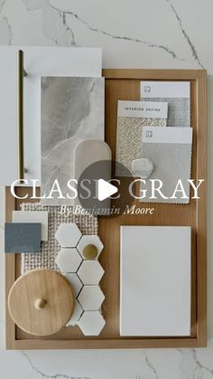 the class gray logo is displayed on top of a wooden tray with papers and other items