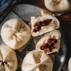 some dumplings are sitting on a plate and ready to be eaten