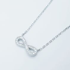 Sterling silver infinity sign necklace set with cubic zirconia. The infinity sign measures 14.5mm wide and 5.5mm tall. The chain is adjustable from 16 to -8 inches.  ---------------------------------------------------- Features ---------------------------------------------------- ◇ Nickel free. ◇ Hypoallergenic ◇ Comes gift ready and packaged in a jewellery box. Shipping ---------------------------------------------------- ⭐︎ Free shipping is by standard post and is not tracked. ⭐︎ If you prefer to have a tracking number, please upgrade to express shipping at checkout to receive full tracking and faster delivery ---------------------------------------------------- ⭐︎ Please visit our shop: www.etsy.com/shop/OstaraCollection to see more of our unique designs Infinity Sign, Sign Necklace, Dress Indian, The Infinity, Wedding Jewellery Necklace, Wedding Necklace, Cotton Dress, Necklace Set, Wedding Jewelry