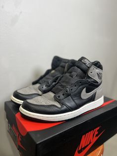 Elevate your sneaker collection with these classic Jordan 1 Retro High OG Shadow 2018 kicks. The black leather upper, along with the high top shoe shaft style, exudes a sleek, retro vibe that's perfect for any casual occasion. These athletic sneakers come in size 10 and feature the iconic Air Jordan 1 model, making them a must-have for any sneakerhead looking to add to their collection. The shoe's details, such as the Style Code 555088-013 and the Retro theme, add to its unique appeal. Whether you're hitting the gym or just running errands, these Air Jordan 1s provide both comfort and style. Used With box and 2 lace colors (black and grey) Air Jordan 1s, High Top Shoe, Jordan 1s, Retro Theme, Jordan 1 Retro High, Jordan 1 Retro, Model Making, Sneaker Collection, Athletic Sneakers