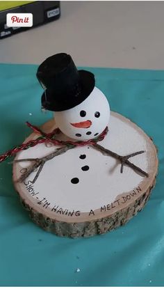 a wooden slice with a snowman on it