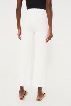 A Tuckernuck staple, the Ivory Ashford Pants are your new wear anytime, anywhere bottom. Crafted from a stretch knit fabric that holds you in with the perfect touch of compression, this closet staple features a high rise and cropped kick flare hem that is equally flattering and effortless. We are pairing these throw-on-and-go bottoms with everything from blouses to sweaters to blazers. High rise Elastic waistband Pull on styling, no zipper Cropped kick flare hem Compression knit fabric Material: Fitted Cream Pants With Straight Hem, Cream Fitted Pants With Straight Hem, White Straight Elastane Pants, Chic White Elastane Pants, Spring White Wide Leg Elastane Pants, White High-waisted Elastane Pants, White High-waisted Elastane Bottoms, White Elastane Ankle-length Bottoms, Cream Straight Hem Bottoms For Work