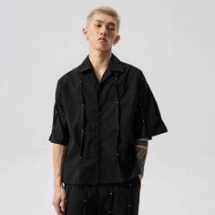 Make a bold statement with the Studded Oversized Button-Up Shirt, where comfort meets a touch of rebellion. Crafted from a premium blend of 94.1% polyamide fiber (nylon) and 5.9% polyurethane elastic fibers (spandex), this shirt provides both stretch and breathability. Its relaxed fit and detailed studding add an edgy texture to the classic silhouette, perfect for those who value quality and a hint of nonconformity in their wardrobe. Whether styled over a graphic tee for a casual day out or butt Daily Look, Black Shirt, Button Up Shirts, Button Up, Graphic Tees, Relaxed Fit, Sleeve Length, Wardrobe, Black