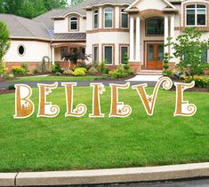 a large sign that says believe in front of a house