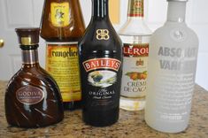 an assortment of liquor bottles sitting on top of a counter