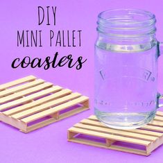 a mason jar sitting on top of a wooden pallet next to a small coaster