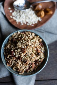 a bowl filled with rice and nuts next to a spoon