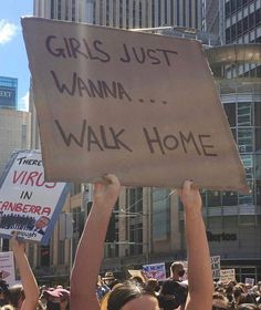 a group of people holding up signs in the air