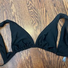 Never Worn, Perfect Condition Fits True To Size No Padding Black Backless Halter Top With Built-in Bra, Black T-back Halter Top For Poolside, Black Triangle Top Swimwear For Vacation, Black T-back Halter Top For Sunbathing, Black Stretch Halter Top For Beach, Black Beachwear Halter Top For Pool, Black Halter Top For Beach Season, Black Halter Neck Top For Vacation, Black Backless Halter Top For The Beach