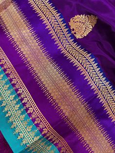 SILK MARK CERTIFIED !!! Stunning Pure Handloom Katan Silk Saree with Satin Patta Border in Eggplant Purple and Sky Blue Color. Border is 7 inches wide. The Butta on the saree is dense on the pallu side while its scattered on other end of the saree. Item : SareeBase Fabric : Pure Katan Silk Color : Purple and Sky Blue Blouse piece : Comes with un-stitched Blouse piece.Blouse material : Pure Katan Silk Fall & Edging(Yes/No) : YesSilk Mark Certificate given with the Saree(Yes/No) : Yes Disclaimer - Purple Celebration Dupatta With Traditional Patterns, Purple Traditional Wear With Motifs For Celebration, Celebration Purple Dupatta With Motifs, Celebration Purple Dupatta With Traditional Patterns, Purple Sets With Motifs For Traditional Ceremonies, Celebratory Purple Dupatta With Motifs, Purple Saree With Traditional Patterns For Celebration, Purple Motif Saree For Celebrations, Ceremonial Purple Saree With Zari Work