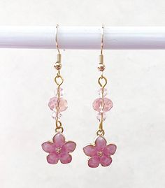 These enamel pink cherry blossom dangle earrings are handmade by myself.  The flowers have crystal accent beads, and the wires are gold plated, hypoallergenic, nickel and lead free.  The actual flower measures 1/2 of an inch. If you have any questions, please ask.  If something wouldn't be right it would be by accident.  Please let me know so I can help you and make it right.  I want you to be happy! It's best to store the item in a plastic bag to keep it shiny.  I am not sure of the exact metal Cherry Blossom Jewelry, Cherry Blossom Earrings, Blossom Jewelry, Pink Cherry Blossom, Pink Cherry, Earrings Crystal, Pink Enamel, Enamel Flower, Crystal Flower