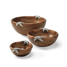 three wooden bowls with silver starfishs on the top and one in the middle