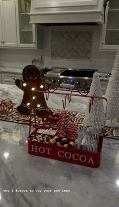 two trays filled with christmas treats on top of a kitchen counter next to an oven