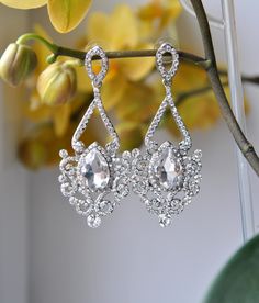 Crystal Bridal Earrings Wedding Long Bridal earrings Bridal chandeliers Bridesmaids Chandelier Great Gatsby 1920s Jewelry Crystal Earrings Elegant glamour traditional wedding crystal earrings with top quality cubic zirconia to create amazing sparkle. They sparkle from every direction! A perfect addition to any occasion. Beautiful earrings made from Cubic Zirconia detailed posts with Large sparkly dangle Cubic Zirconia tear drops and surrounded by tiny cubic zirconia crystals. Made for pierced ea Ornate Silver Chandelier Earrings For Wedding, Vintage Teardrop Bridal Earrings For Wedding, Silver Vintage Chandelier Earrings For Wedding, Vintage Silver Chandelier Earrings For Wedding, Ornate Wedding Chandelier Earrings With Elegant Design, Ornate Teardrop Chandelier Earrings For Wedding, Vintage Teardrop Chandelier Earrings For Wedding, Vintage Crystal Chandelier Earrings For Wedding, Ornate Bridal Earrings With Elegant Design